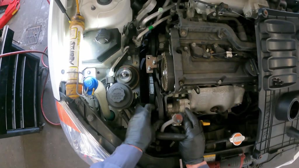 Step 6: Move the power-steering pump and reservoir aside