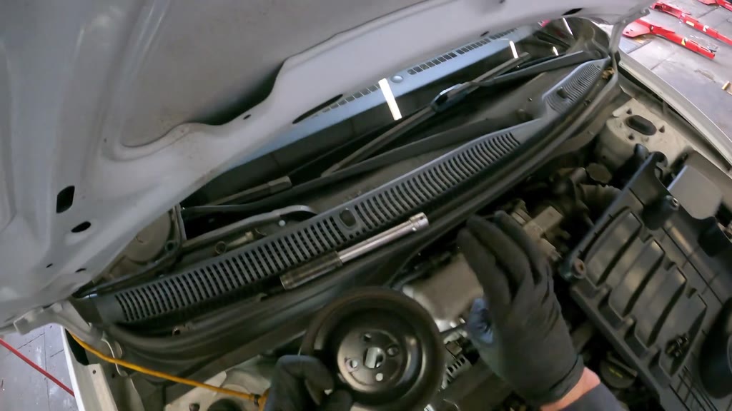 Step 7: Remove the upper accessory pulleys and belts