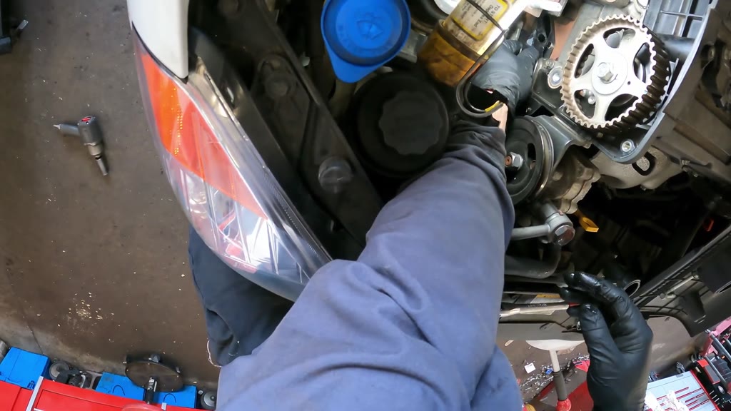 Step 23: Coat and position the replacement water-pump gasket