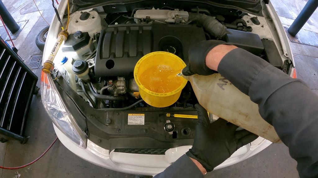 Step 40: Fit the coolant funnel and begin filling