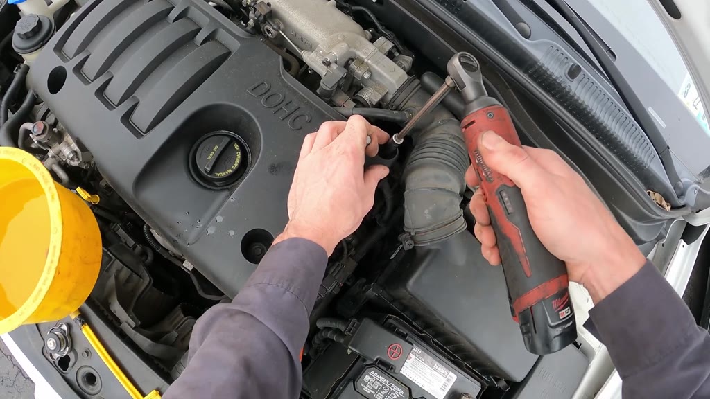 Step 45: Secure the engine-cover bolt beside the intake hose